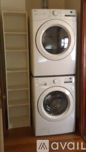 Two white washing machines stacked on top of each other.