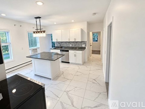 A modern kitchen with a black stove top oven.