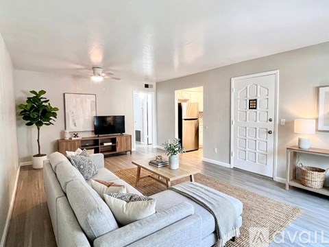A living room with a grey sofa and a television.