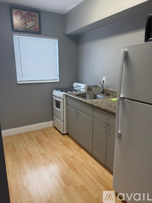 A kitchen with a fridge, dishwasher and a sink.