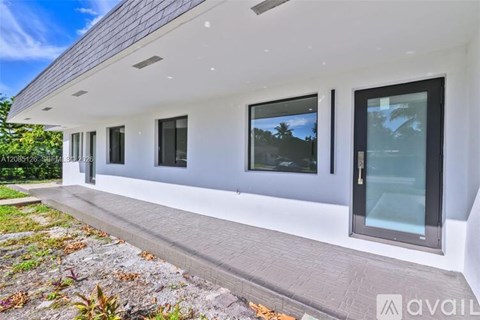 A modern house with a white exterior and large windows.