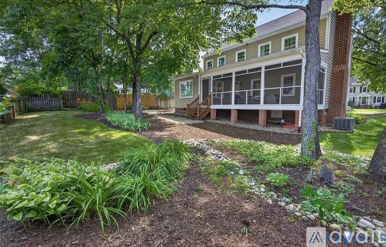 A house with a well-maintained garden in front.