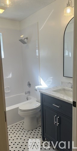 A bathroom with a white toilet and a sink.