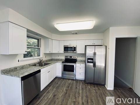 A kitchen with white cabinets and stainless steel appliances.