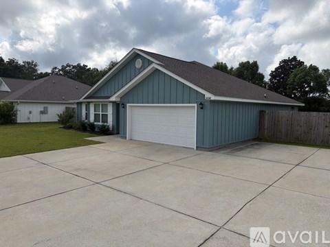 A blue house with a white garage door.