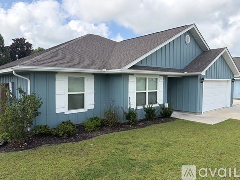 A house with a blue exterior and a brown roof.