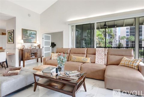 A living room with a large sectional sofa and a coffee table.