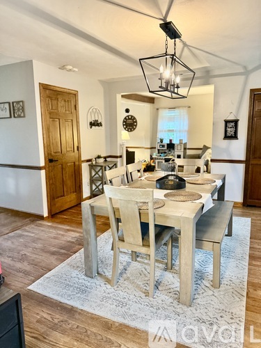 A dining room with a table set for four.
