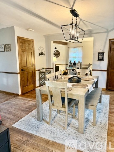 A dining room with a table set for four.
