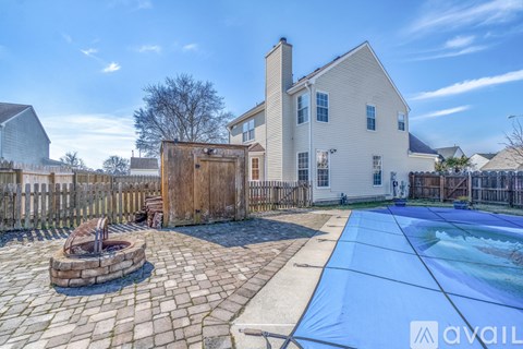 A house with a pool and a hot tub in the backyard.