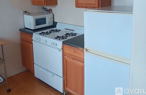A white stove and refrigerator in a kitchen.
