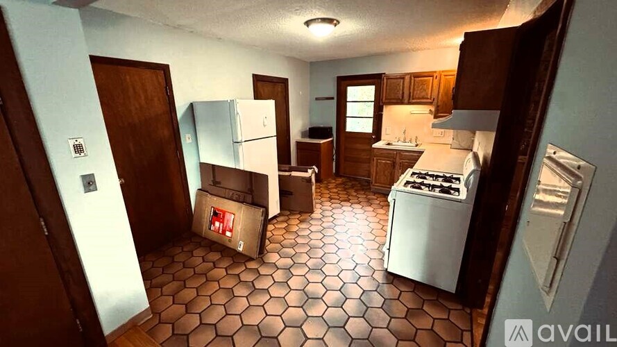 A kitchen with a white fridge and a washing machine.