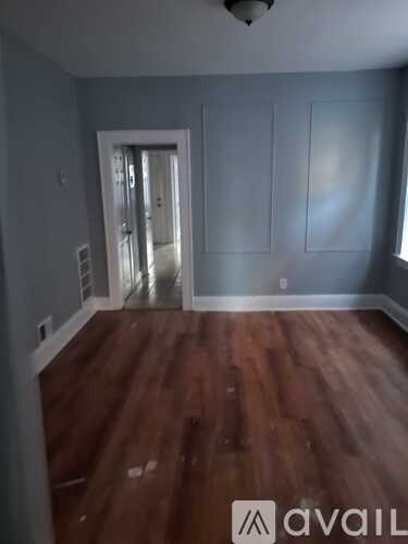 A room with wooden floors and a white door.