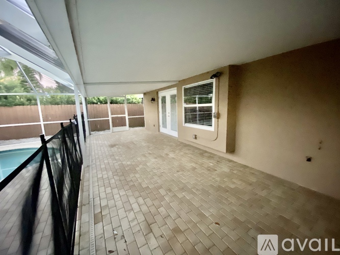 A balcony with a black railing and a tiled floor.