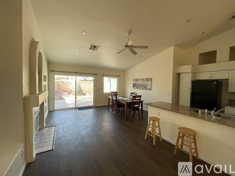 A living room with a dining table and chairs.
