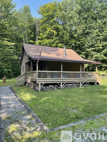 A house with a porch and a flag on it.