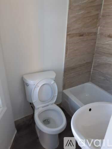 A white toilet in a bathroom with a white bidet.