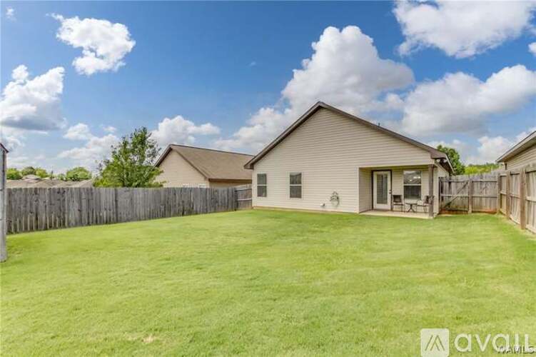 A house with a fenced backyard is for sale.