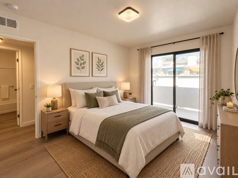 A spacious room with a staircase and a ceiling fan.
