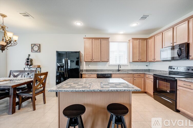 A kitchen with wooden cabinets and a granite countertop.