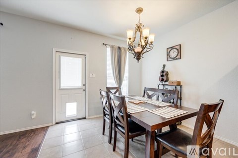 A dining room with a wooden table and chairs.