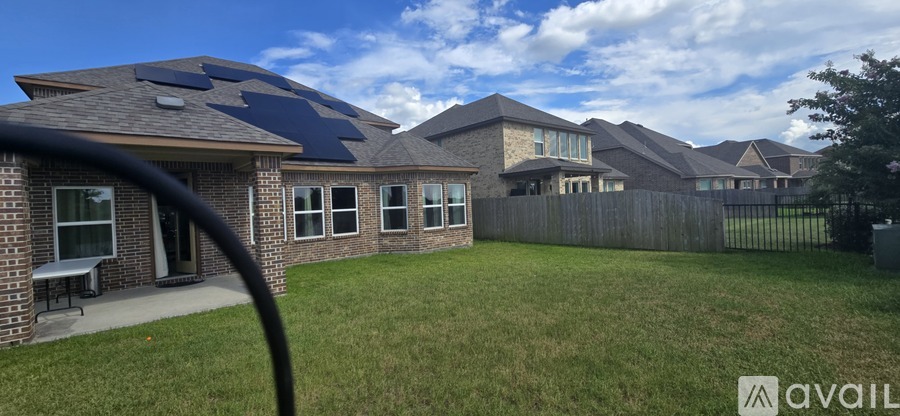 A house with a blue roof and a grassy yard.