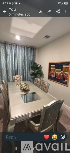 A dining room with a table set for four.