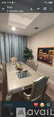 A dining room with a table set for four.