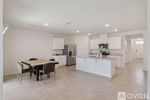 A modern kitchen with a dining table and chairs.