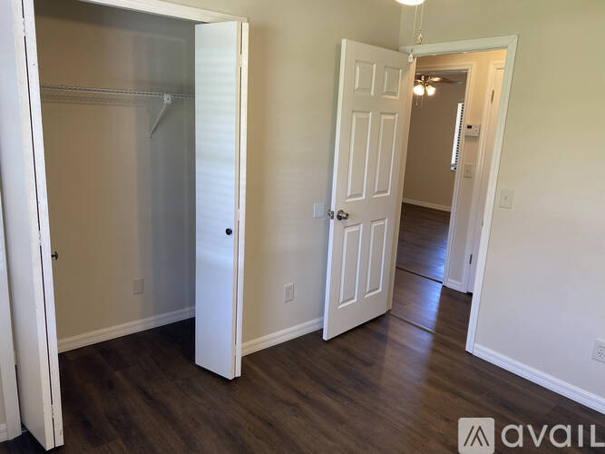 A white door is open to a hallway.
