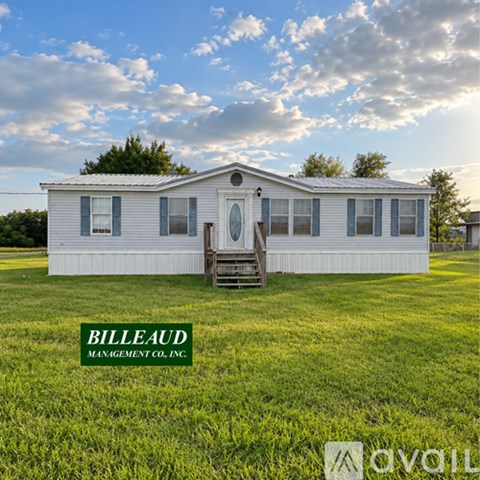 A white house with a green logo that says "BILLEAUD MANAGEMENT CO. INC." in front of it.