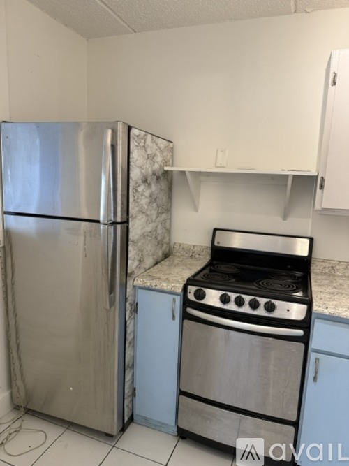 A kitchen with a stainless steel refrigerator and stove.
