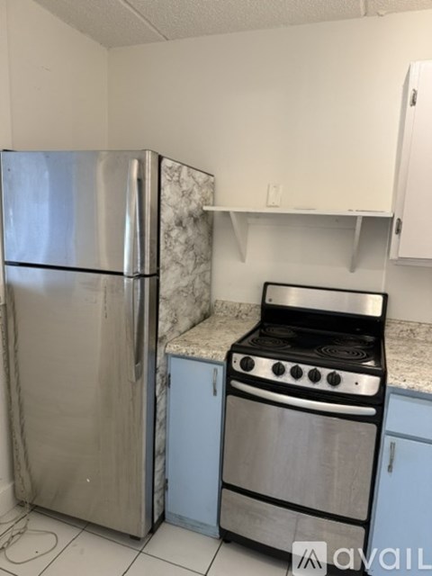 A kitchen with a stainless steel refrigerator and stove.