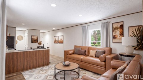A living room with a brown leather couch and a wooden coffee table.