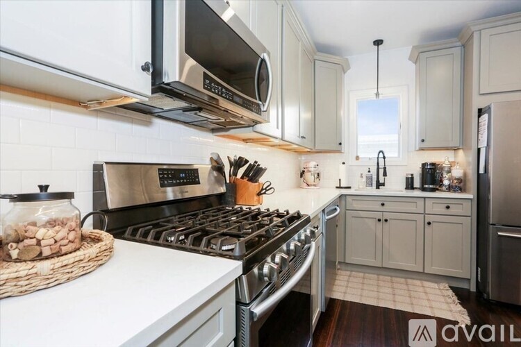A kitchen with a stove top oven and a refrigerator.