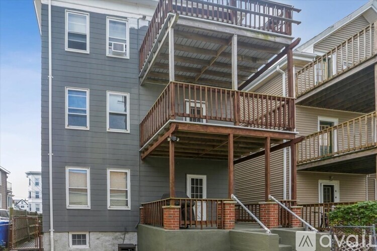 A multi-story building with a balcony on the second floor.