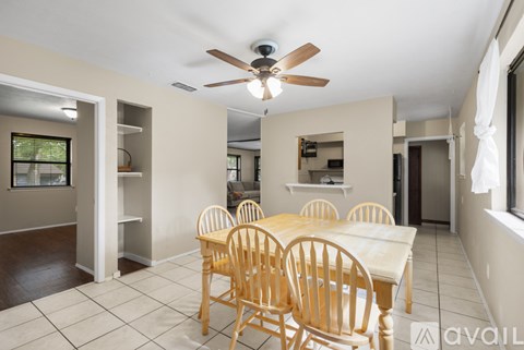 A dining room with a table and chairs.