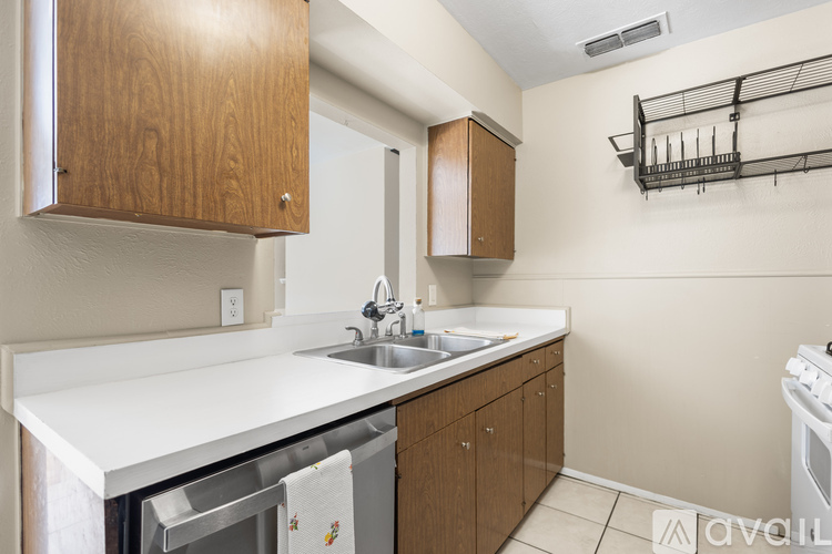 A kitchen with wooden cabinets and a white countertop.