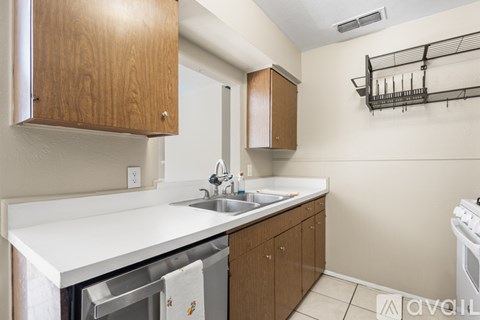 A kitchen with wooden cabinets and a white countertop.
