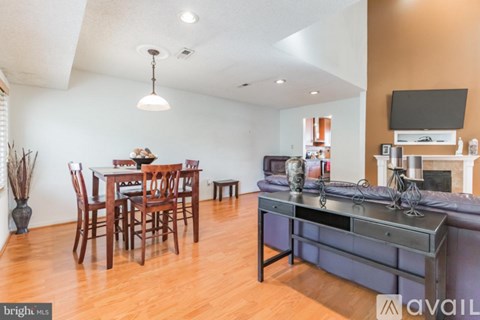 A living room with a dining table and chairs.