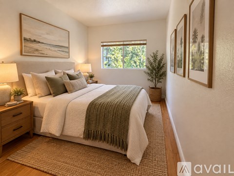 A bedroom with a large bed and a window.
