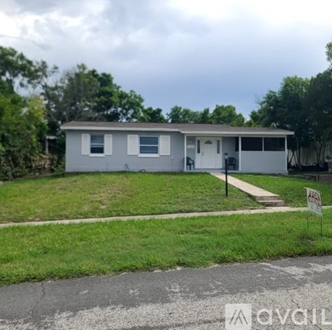 A house with a white door and windows is for sale.