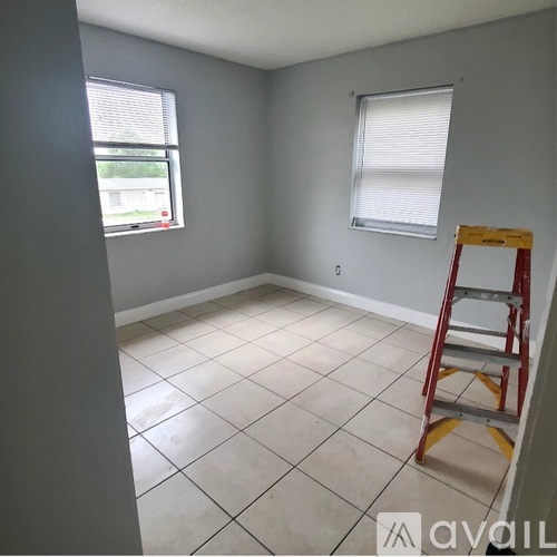 A room with a ladder and a window.