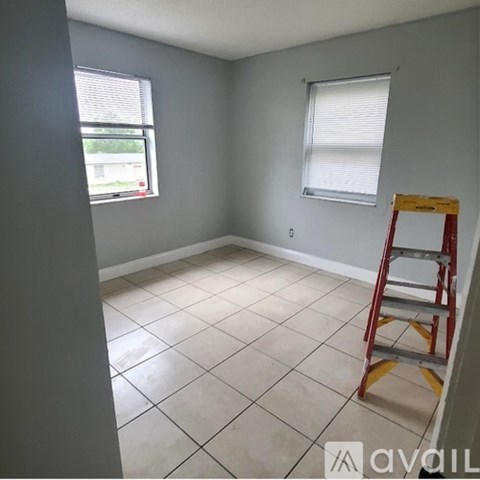 A room with a ladder and a window.