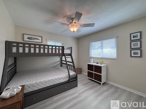 A bedroom with a bunk bed and a dresser.