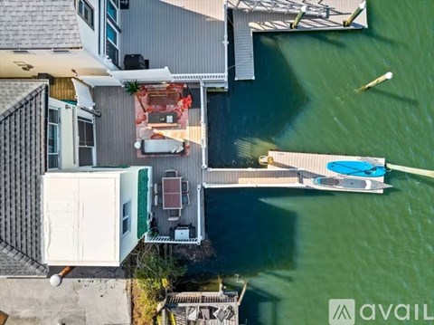 A boat is docked at a pier next to a building.