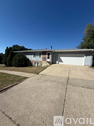 A house with a garage is for sale.