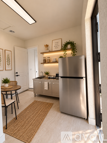 A modern kitchen with a stainless steel refrigerator and a dining table with chairs.