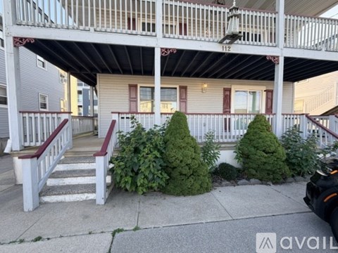 A house number 112 with a porch and steps leading to it.