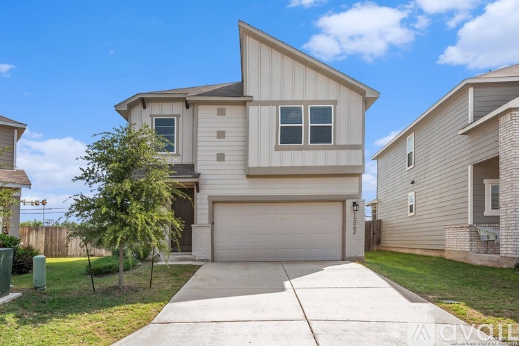 A two-story house with a garage is for sale.